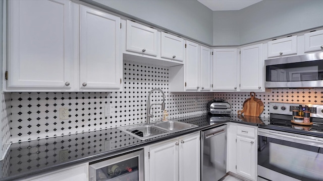 2608 Bering Dr Unit 2608, Houston, TX 77057 - kitchen featuring appliances with stainless steel finishes, dark countertops, white cabinetry, beverage cooler, and backsplash