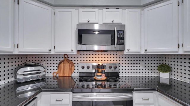 2608 Bering Dr Unit 2608, Houston, TX 77057 - kitchen featuring stainless steel appliances, dark countertops, white cabinetry, and backsplash