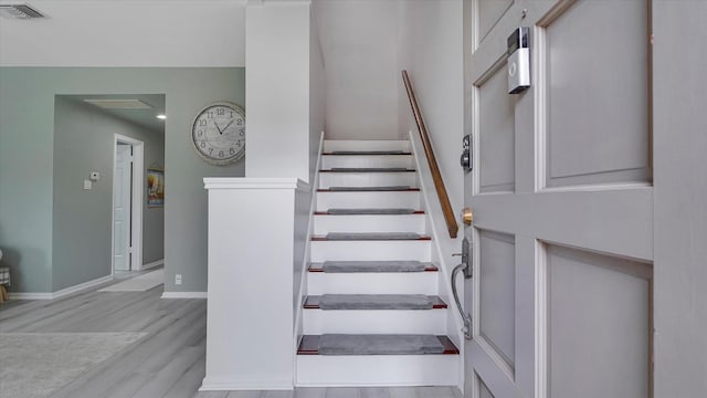2608 Bering Dr Unit 2608, Houston, TX 77057 - staircase with wood finished floors and recessed lighting