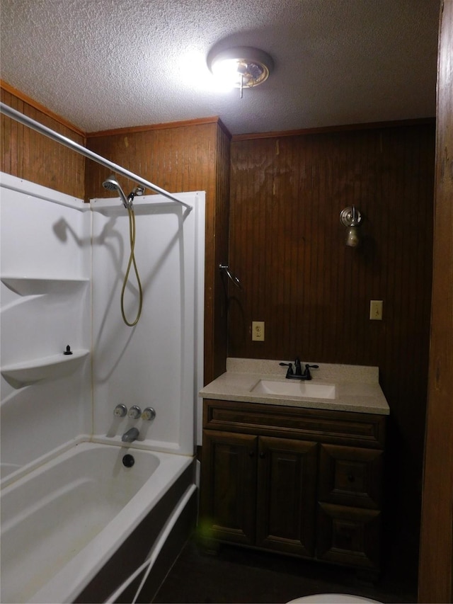415 E Sherwood Dr, Livingston, TX 77351 - full bathroom featuring  shower combination, a textured ceiling, wood walls, and vanity