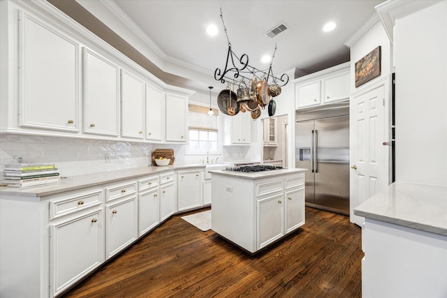 3827 Marquette St, West University Place, TX 77005 - kitchen featuring stainless steel appliances, a chandelier, white cabinets, backsplash, and ornamental molding