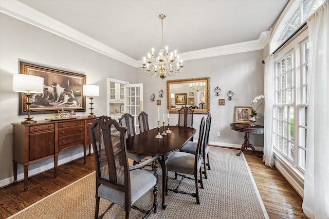 3827 Marquette St, West University Place, TX 77005 - dining space featuring a chandelier, healthy amount of natural light, crown molding, and wood finished floors