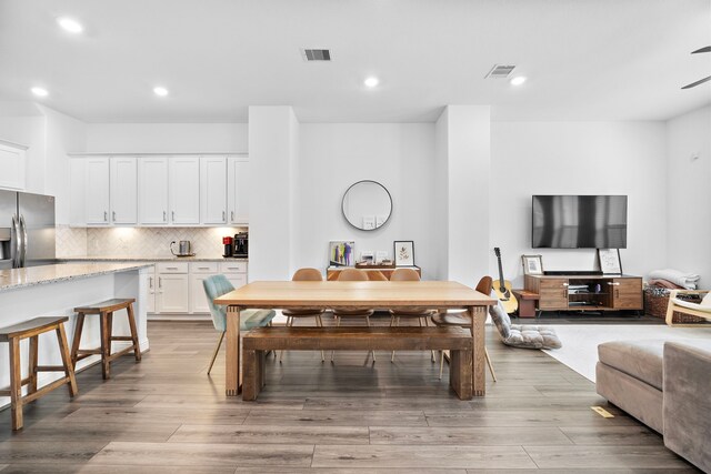 11008 Mikula Dr, Houston, TX 77043 - dining space with light wood-style floors and recessed lighting