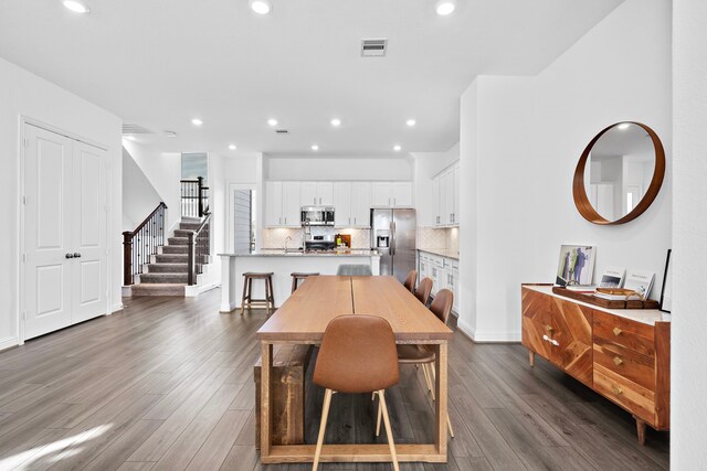 11008 Mikula Dr, Houston, TX 77043 - dining room featuring stairs, dark wood finished floors, and recessed lighting