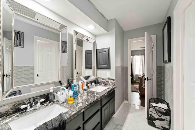 8002 Laguna Springs Ct, Houston, TX 77095 - bathroom featuring double vanity, marble finish floors, and wainscoting