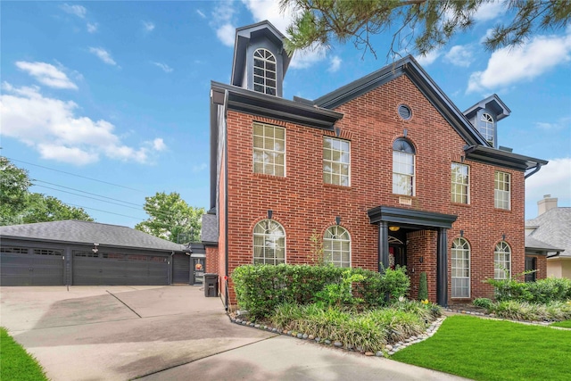 8002 Laguna Springs Ct, Houston, TX 77095 - view of front of home featuring a detached garage, brick siding, and an outdoor structure