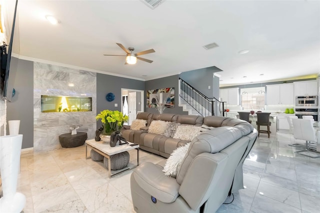 8002 Laguna Springs Ct, Houston, TX 77095 - living area featuring light marble finish floors, stairs, ceiling fan, tile walls, and crown molding