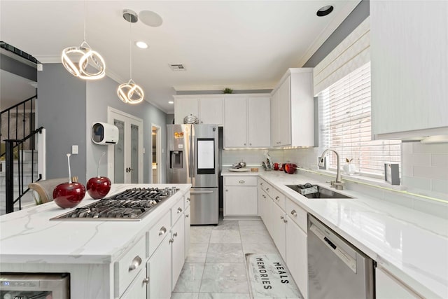 8002 Laguna Springs Ct, Houston, TX 77095 - kitchen with stainless steel appliances, crown molding, light marble finish floors, tasteful backsplash, and white cabinetry