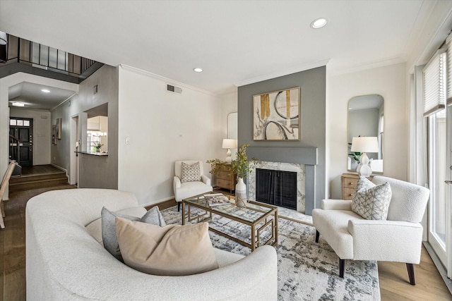 1228 Fountain View Dr Unit 180, Houston, TX 77057 - living area featuring crown molding, plenty of natural light, wood finished floors, a fireplace, and recessed lighting