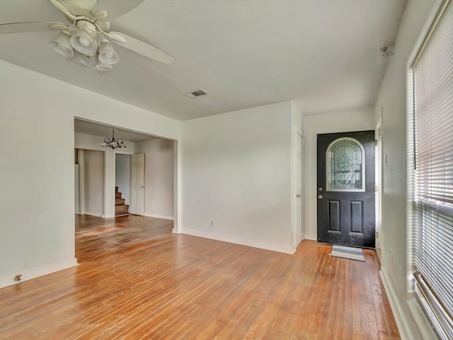 1214 W 6th St, Freeport, TX 77541 - entrance foyer featuring light wood finished floors, stairway, ceiling fan, and a chandelier