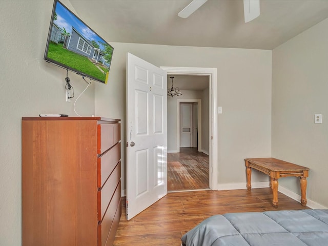 1214 W 6th St, Freeport, TX 77541 - bedroom featuring wood finished floors, a chandelier, and ceiling fan