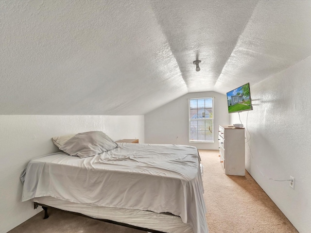 1214 W 6th St, Freeport, TX 77541 - bedroom with vaulted ceiling, light colored carpet, a textured ceiling, and a textured wall