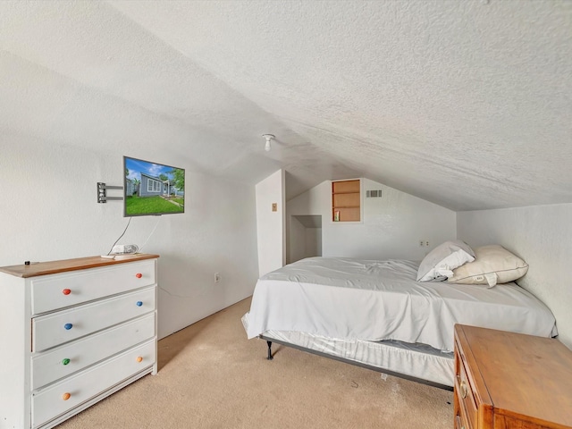 1214 W 6th St, Freeport, TX 77541 - bedroom featuring light carpet, vaulted ceiling, and a textured ceiling