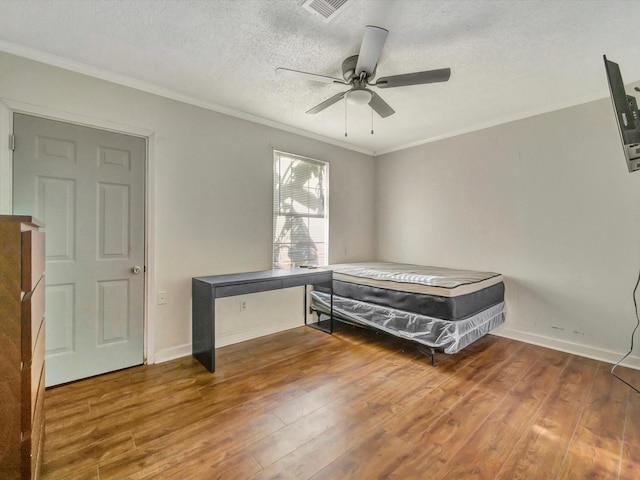 1214 W 6th St, Freeport, TX 77541 - bedroom with ornamental molding, wood finished floors, a textured ceiling, and a ceiling fan