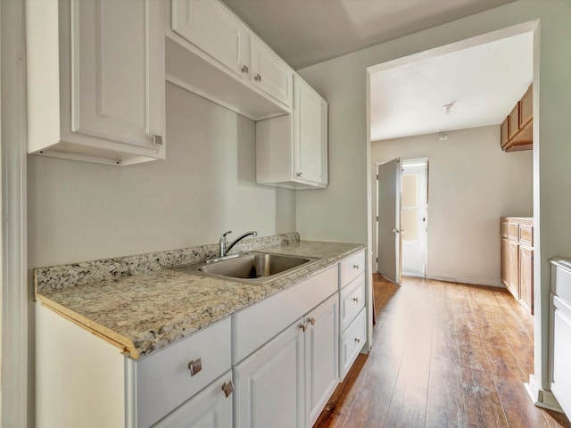 1214 W 6th St, Freeport, TX 77541 - kitchen featuring light wood-style flooring and white cabinets