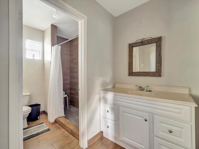 1214 W 6th St, Freeport, TX 77541 - bathroom featuring vanity, wood finished floors, and a shower with shower curtain