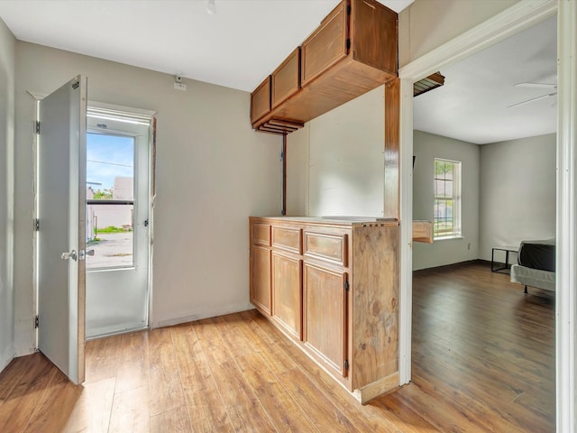 1214 W 6th St, Freeport, TX 77541 - kitchen featuring light wood-style floors and brown cabinetry