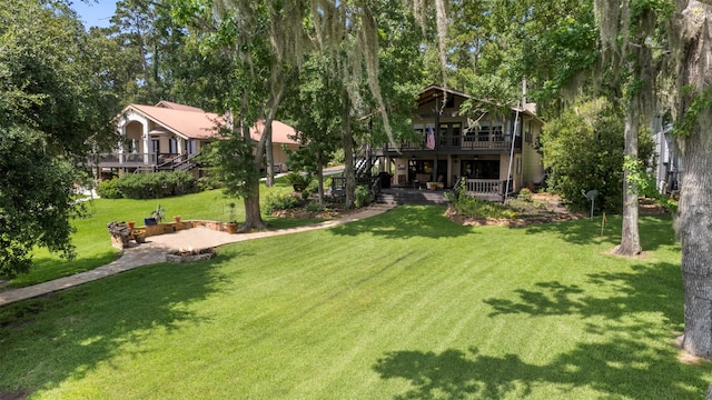 1831 Lakeview Estates Dr, Coldspring, TX 77331 - view of green lawn with stairway, a wooden deck, and a patio area