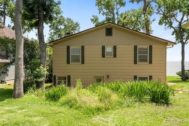 1831 Lakeview Estates Dr, Coldspring, TX 77331 - view of side of home with a yard and a water view