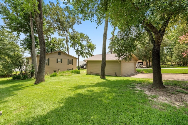 1831 Lakeview Estates Dr, Coldspring, TX 77331 - view of green lawn featuring an outdoor structure and concrete driveway