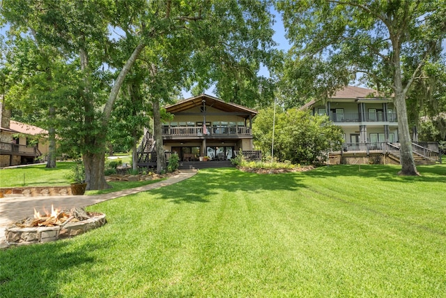 1831 Lakeview Estates Dr, Coldspring, TX 77331 - view of green lawn with stairway, an outdoor fire pit, and a wooden deck