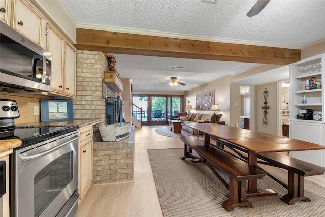 1831 Lakeview Estates Dr, Coldspring, TX 77331 - dining room with a ceiling fan, light wood finished floors, a textured ceiling, crown molding, and a brick fireplace