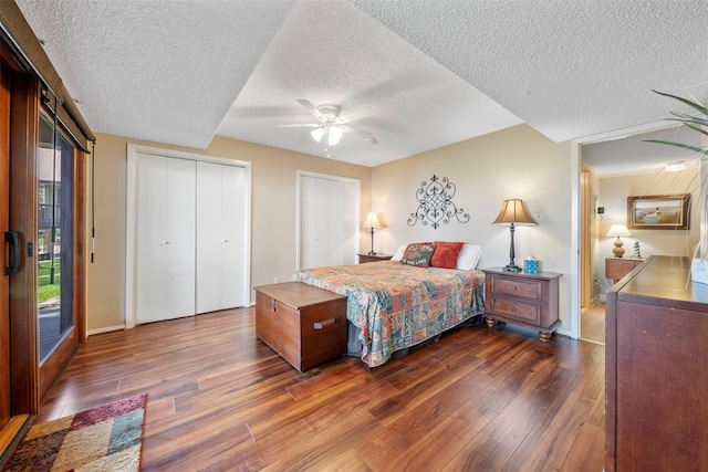 1831 Lakeview Estates Dr, Coldspring, TX 77331 - bedroom featuring a textured ceiling, dark wood finished floors, ceiling fan, multiple closets, and access to exterior