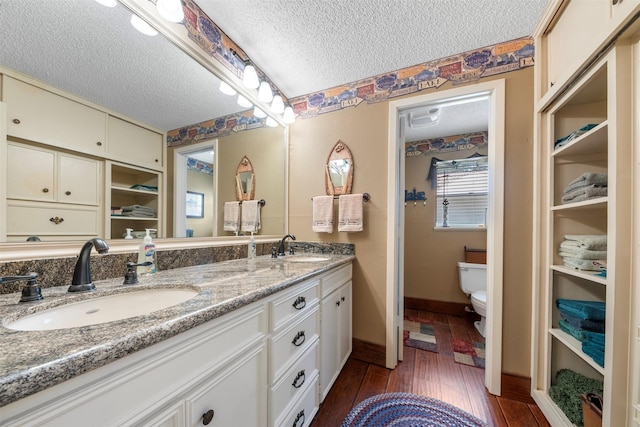 1831 Lakeview Estates Dr, Coldspring, TX 77331 - full bath with a textured ceiling, double vanity, and wood finished floors