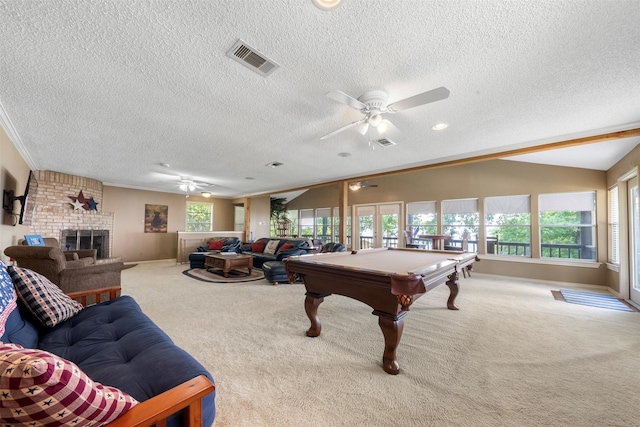 1831 Lakeview Estates Dr, Coldspring, TX 77331 - game room featuring ceiling fan, carpet floors, a textured ceiling, a brick fireplace, and billiards