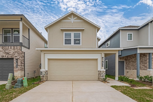 14979 Eagle Feather Dr, Houston, TX 77090 - view of front of home with an attached garage, stone siding, a balcony, and concrete driveway