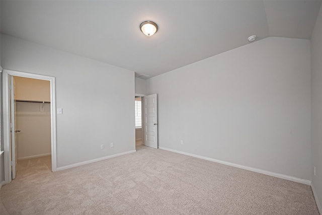14979 Eagle Feather Dr, Houston, TX 77090 - unfurnished bedroom featuring light carpet, a spacious closet, a closet, and lofted ceiling