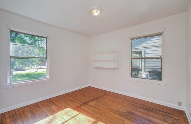 1708 S Park Dr, Alvin, TX 77511 - empty room with healthy amount of natural light and wood-type flooring