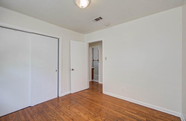 1708 S Park Dr, Alvin, TX 77511 - unfurnished bedroom with wood finished floors and a closet
