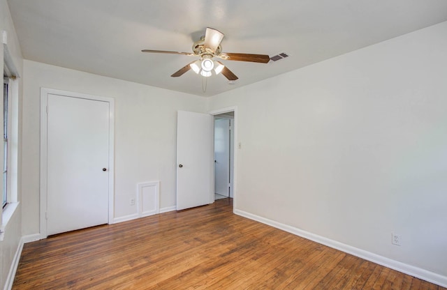 1708 S Park Dr, Alvin, TX 77511 - unfurnished bedroom with wood finished floors and a ceiling fan