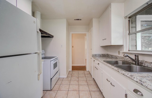 1708 S Park Dr, Alvin, TX 77511 - kitchen featuring white appliances, premium range hood, white cabinetry, light countertops, and light tile patterned flooring