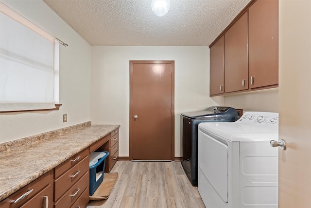 3310 Lake Heights Dr, Waco, TX 76708 - laundry area featuring separate washer and dryer, cabinet space, light wood-type flooring, and a textured ceiling