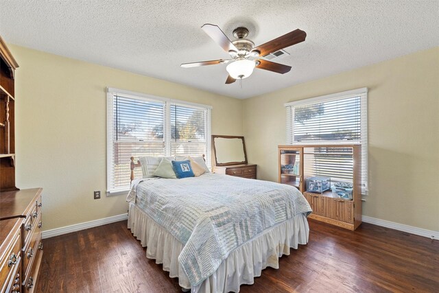 3310 Lake Heights Dr, Waco, TX 76708 - bedroom with dark wood-type flooring, ceiling fan, and a textured ceiling