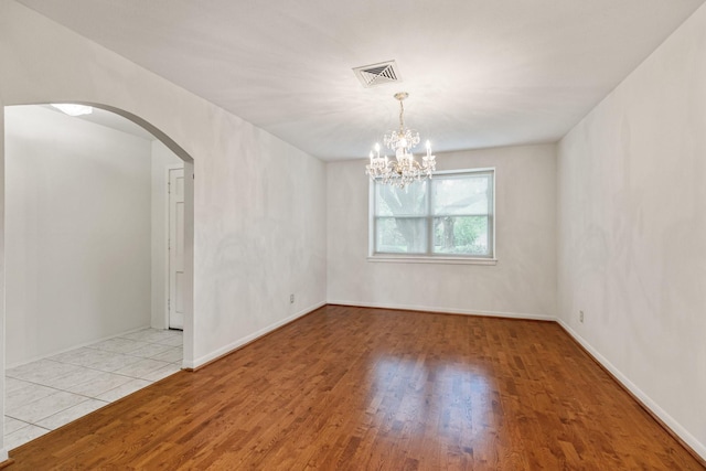 9622 Highmeadow Dr, Houston, TX 77063 - empty room with arched walkways, wood finished floors, and a chandelier