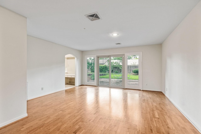 9622 Highmeadow Dr, Houston, TX 77063 - spare room featuring arched walkways and light wood-style floors