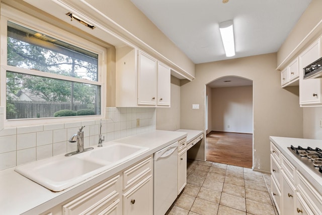 9622 Highmeadow Dr, Houston, TX 77063 - kitchen featuring dishwasher, arched walkways, white cabinetry, light countertops, and backsplash