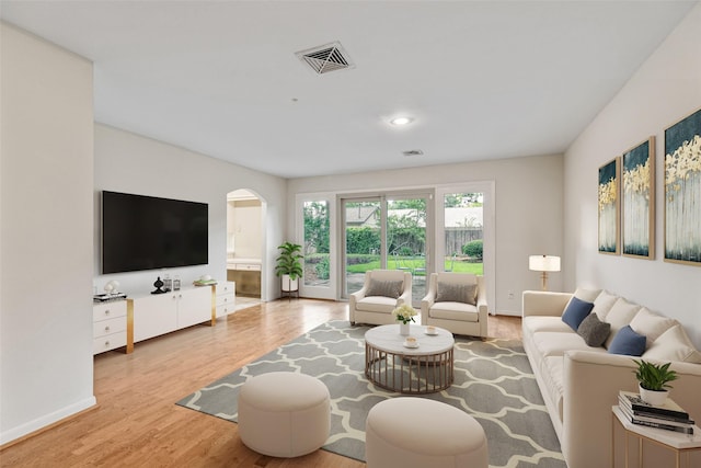 9622 Highmeadow Dr, Houston, TX 77063 - living room featuring wood finished floors, arched walkways, and recessed lighting