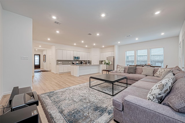 23722 Canolo Grove Ln, New Caney, TX 77357 - living room featuring light wood-type flooring and recessed lighting