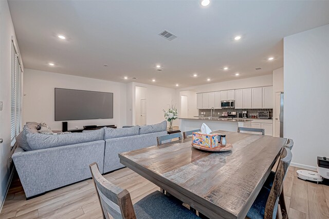 23722 Canolo Grove Ln, New Caney, TX 77357 - dining space featuring light wood finished floors and recessed lighting
