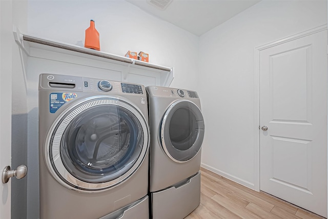 23722 Canolo Grove Ln, New Caney, TX 77357 - washroom featuring washer and clothes dryer and light wood-type flooring
