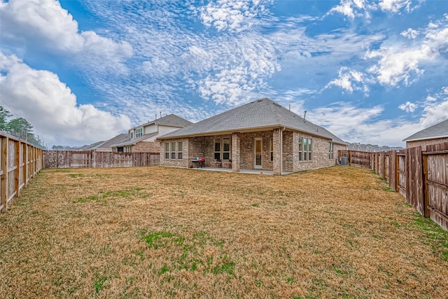 23722 Canolo Grove Ln, New Caney, TX 77357 - back of property with brick siding, a patio area, and a fenced backyard
