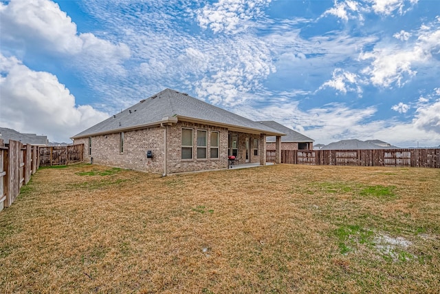 23722 Canolo Grove Ln, New Caney, TX 77357 - back of house featuring brick siding, a fenced backyard, a patio, and a shingled roof