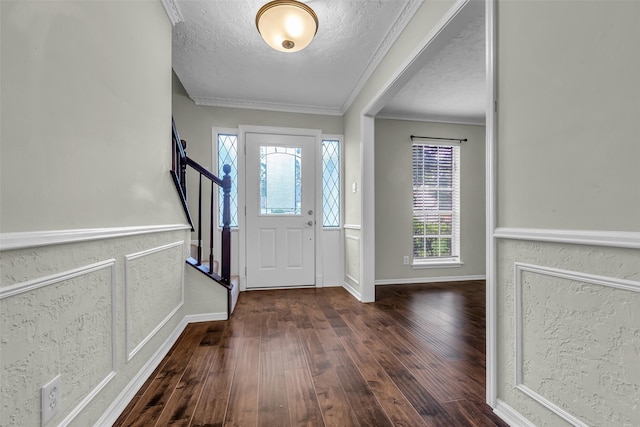 8115 Winding Oak Ln, Spring, TX 77379 - entrance foyer with dark wood finished floors, healthy amount of natural light, a textured ceiling, crown molding, and stairway