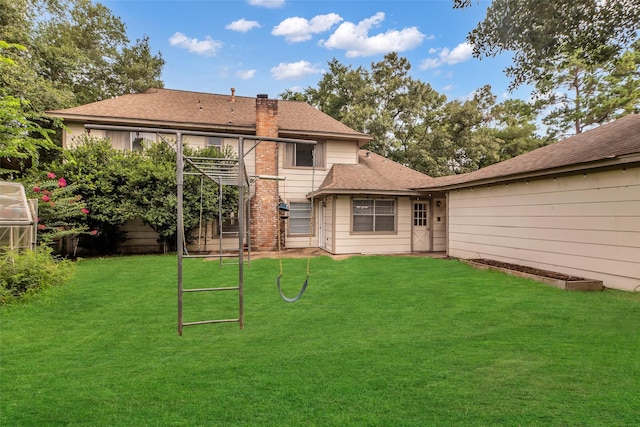 8115 Winding Oak Ln, Spring, TX 77379 - rear view of property with a chimney, a lawn, and a shingled roof
