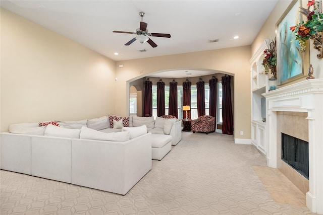 2010 Cias Trail Ln, Spring, TX 77386 - living area featuring arched walkways, a fireplace, ceiling fan, and recessed lighting