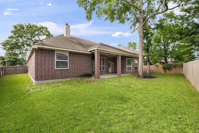 2010 Cias Trail Ln, Spring, TX 77386 - back of house featuring a chimney, brick siding, a fenced backyard, and a patio